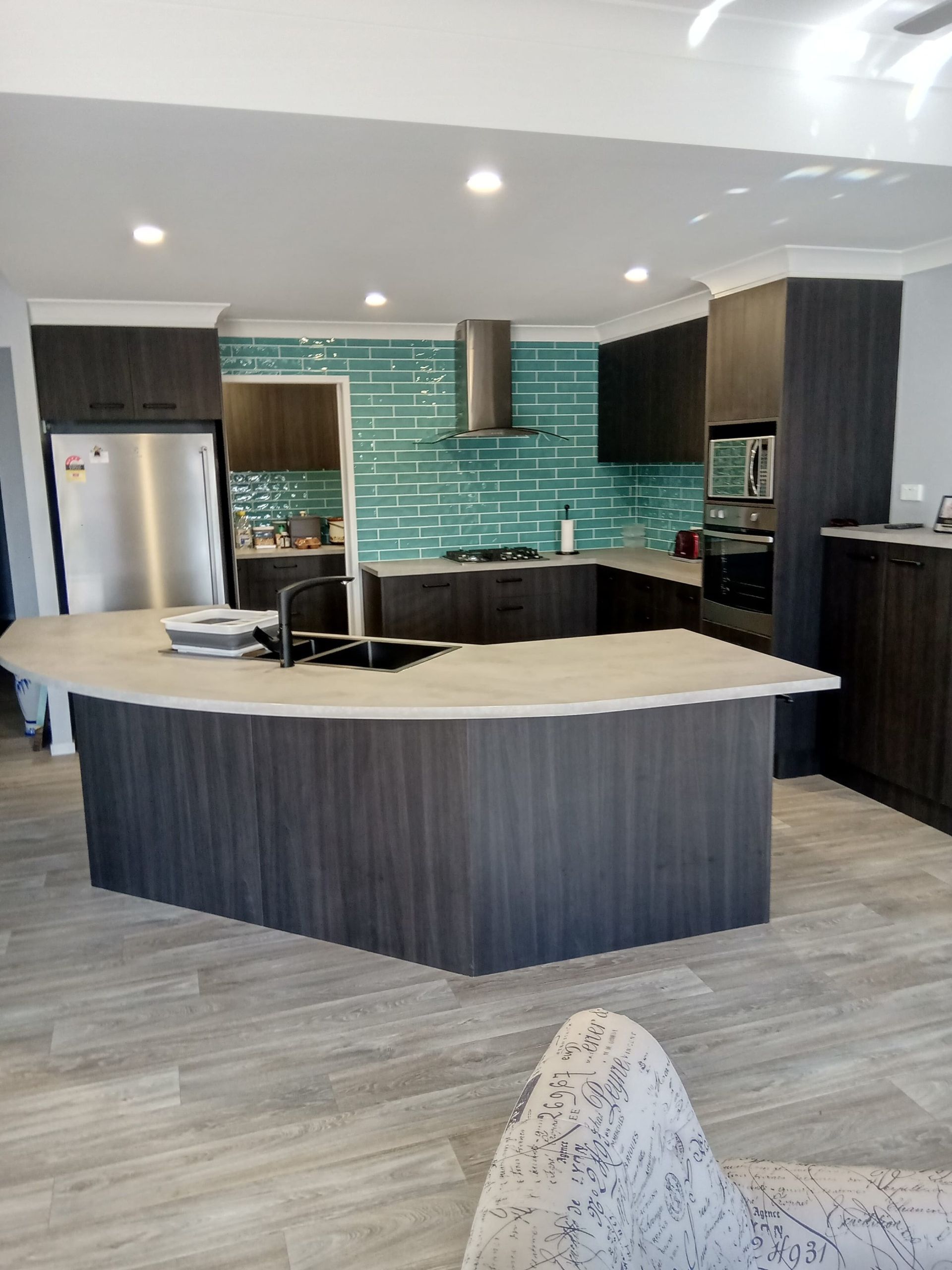 Modern Kitchen Featuring a Curved Island, Dark Wood Cabinets — Craftsmen Kitchens In Monkland, QLD