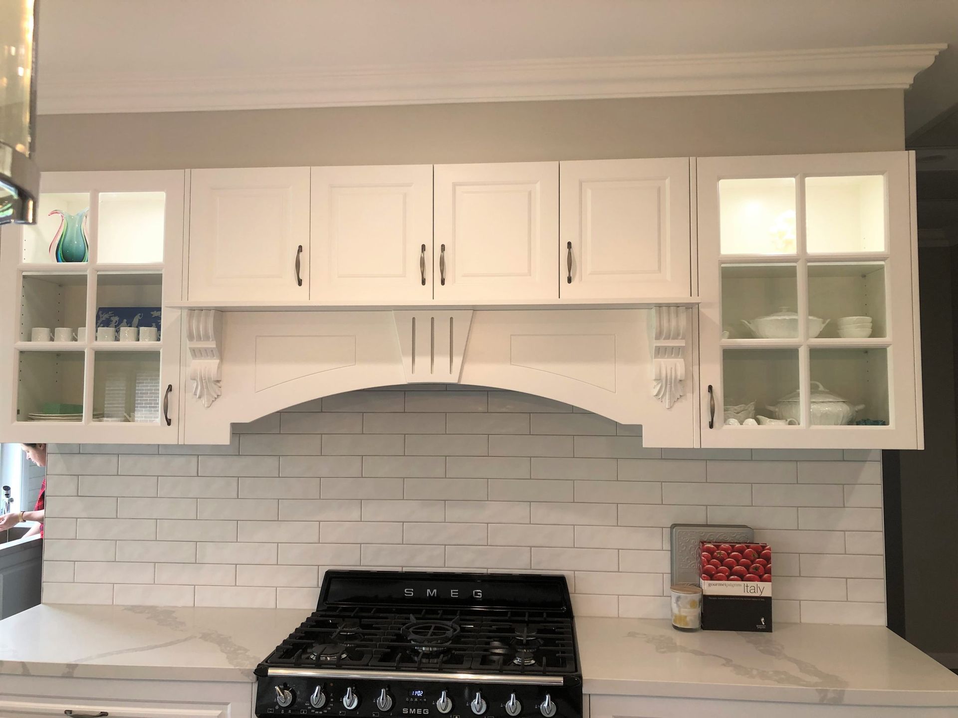 White Kitchen Cabinets With Glass-front Side Doors and a Central Range — Craftsmen Kitchens In Monkland, QLD