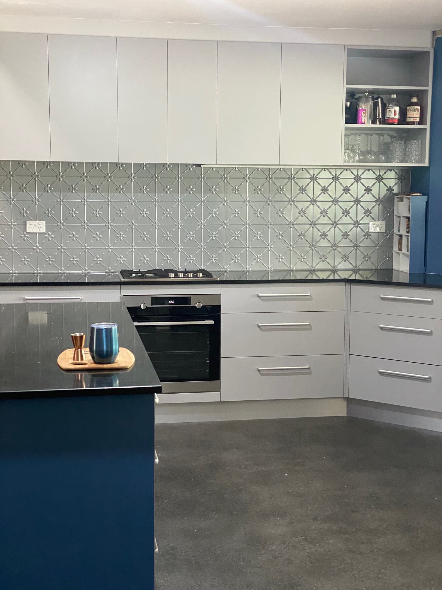 Modern Kitchen With a Dark Blue Island, White Cabinets — Craftsmen Kitchens In Monkland, QLD