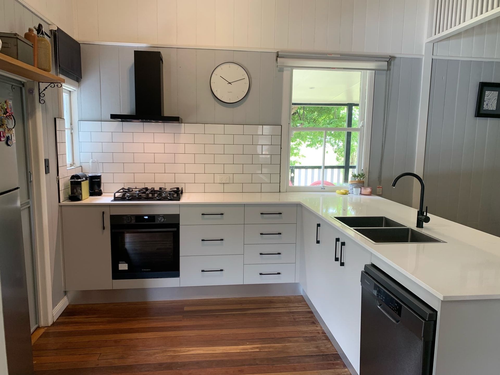 A Modern Kitchen With White Cabinets, Light Countertops — Craftsmen Kitchens In Monkland, QLD