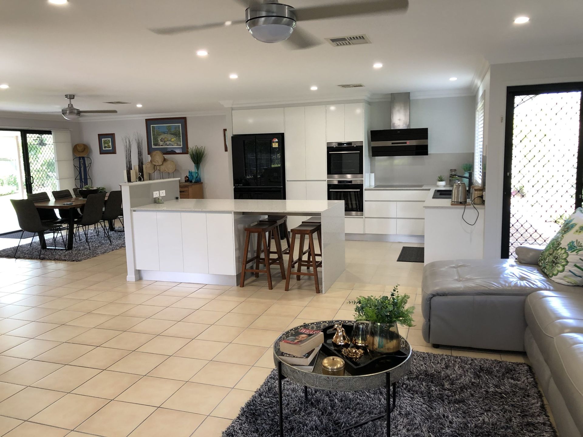 A Spacious, Open-plan Kitchen and Living Area With White Cabinetry — Craftsmen Kitchens In Monkland, QLD