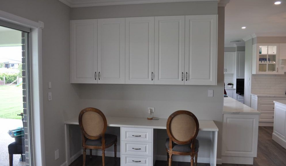 Built-in White Desk With a Three-drawer Unit, Two Chairs, and Overhead Cabinets — Craftsmen Kitchens In Monkland, QLD
