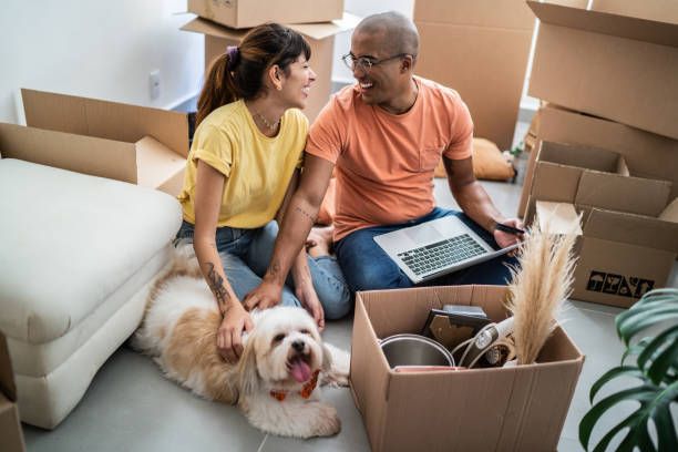 Young Couple Packing And Moving Boxes — Lafayette, LA — Alex Louis Movers