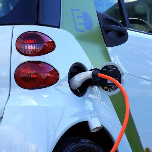 A smart car is plugged into a charging station