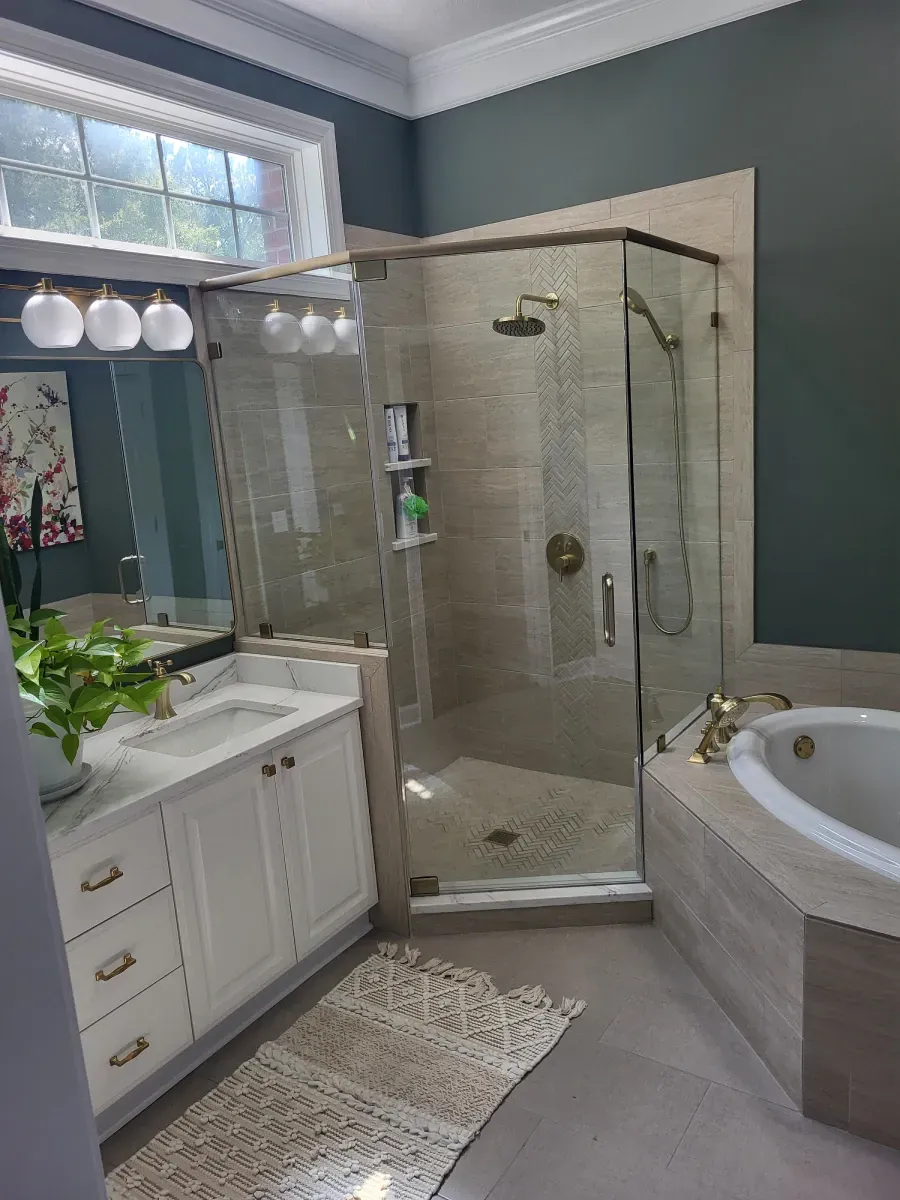 Bathroom with a glass-enclosed shower, white vanity, and a built-in bathtub, with a green wall.