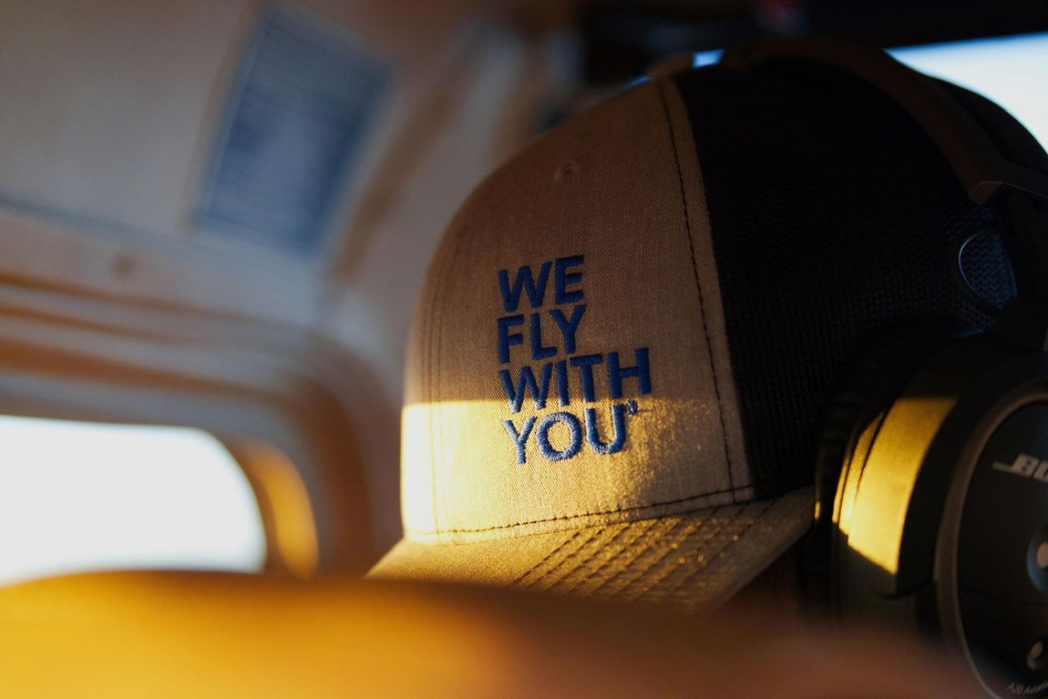 Elite Aero MX hat embroidered with “We Fly With You” aviation maintenance slogan
