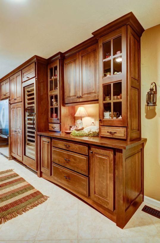Wooden wall unit and cabinets in a bright hallway, with built-in shelves and drawers.