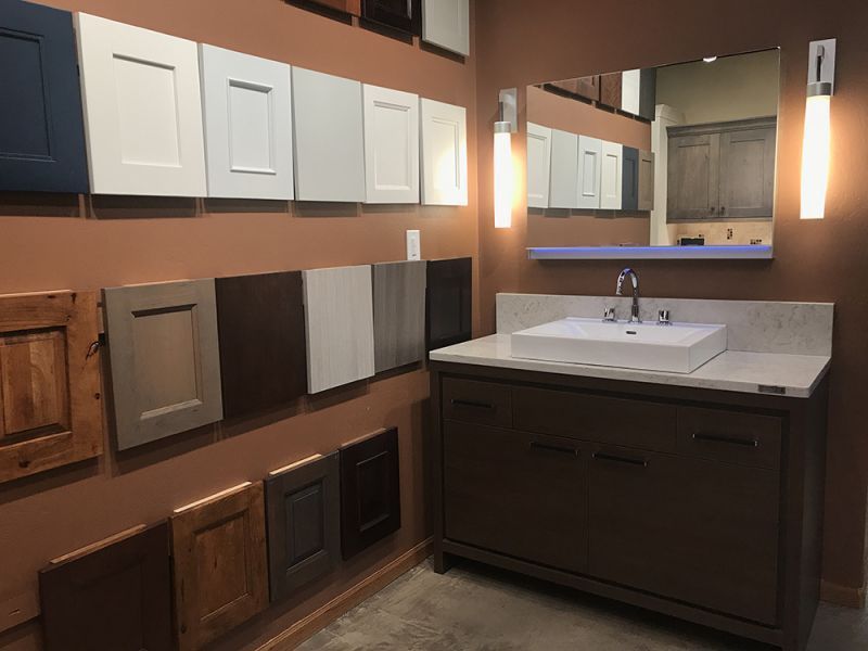 Modern bathroom vanity with mirror, wall cabinets, sink, and warm lighting
