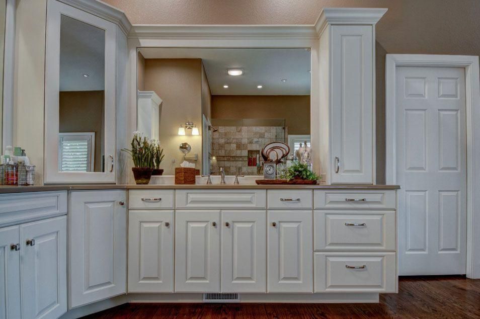 Bright white bathroom vanity with mirror, sink, and towel storage, in a modern interior