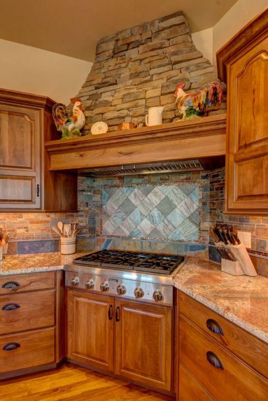 Warm kitchen with wooden cabinets, stone range hood, and tiled backsplash over a stainless steel stove.
