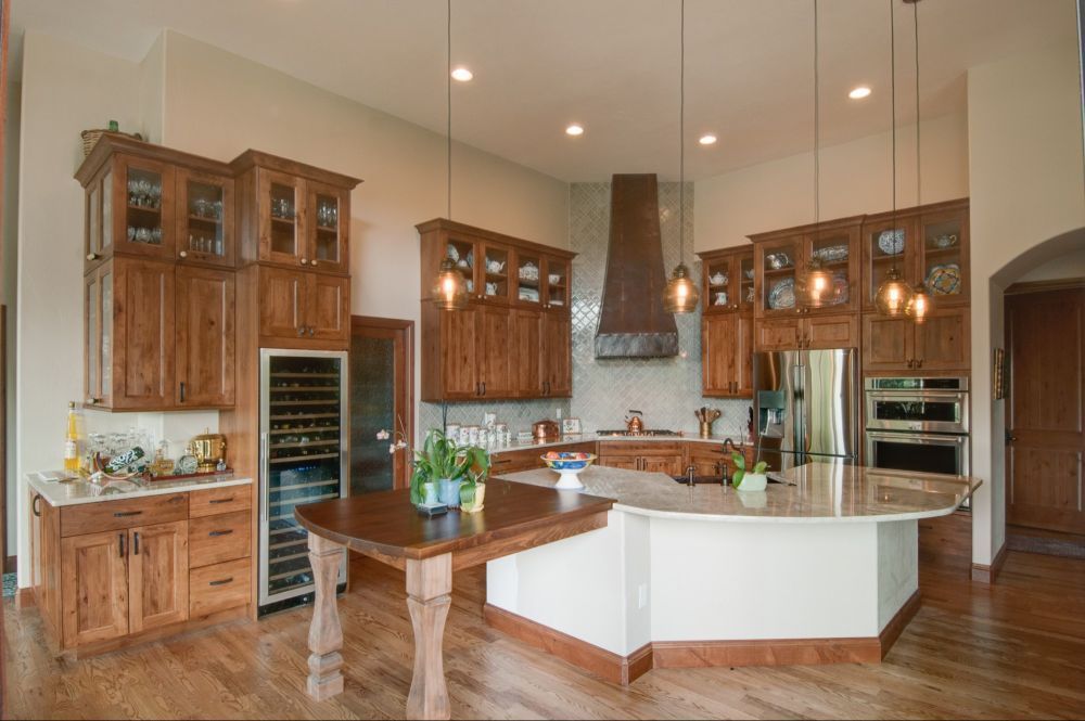 Spacious kitchen with wood cabinets, granite island, and stainless steel range hood