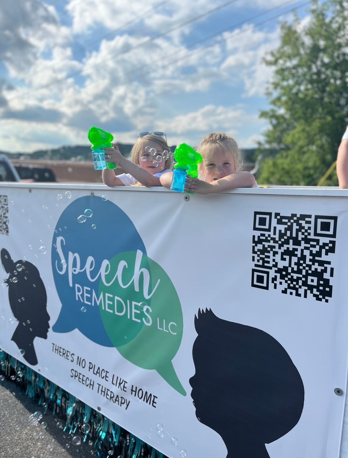 two children holding a bubbles
