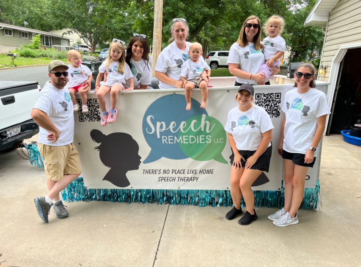 A group of people standing in front of a sign that says speech remedies