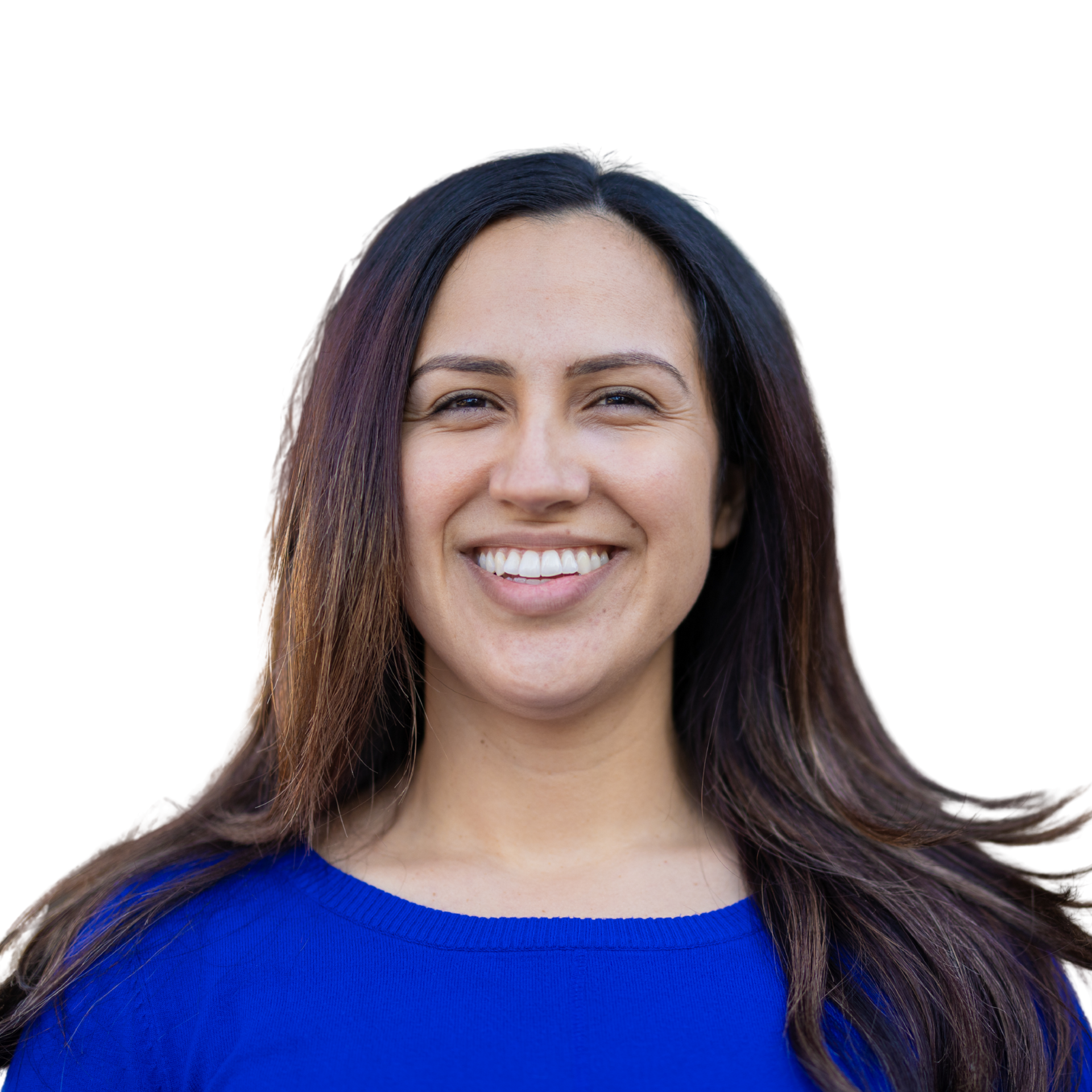 A person with long dark hair smiling broadly, wearing a bright blue top against a plain white background.