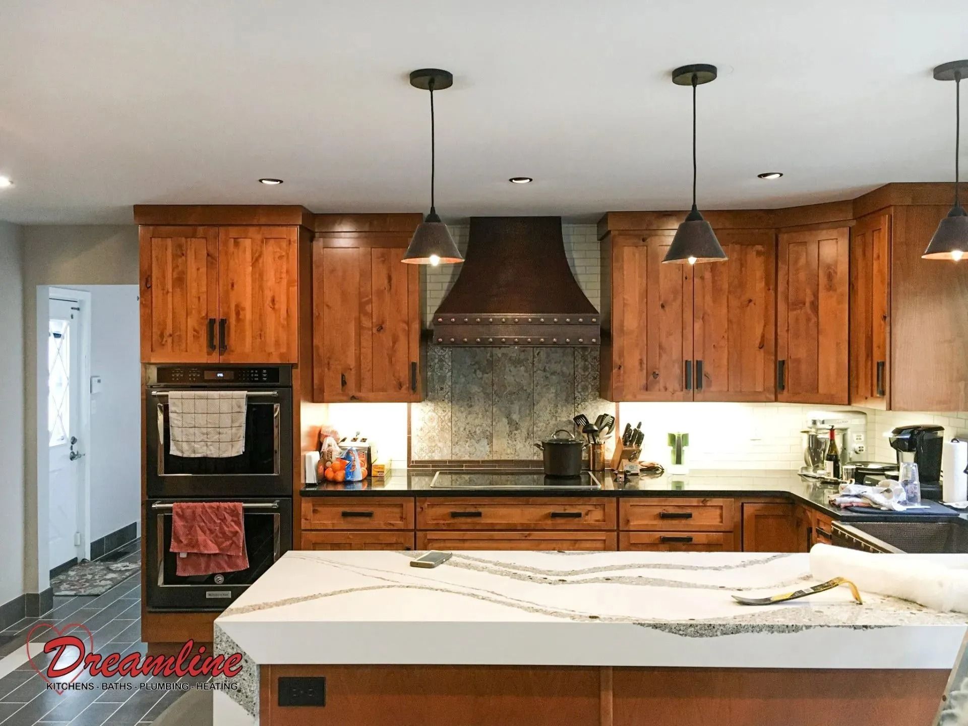 A kitchen with wooden cabinets and a white counter top