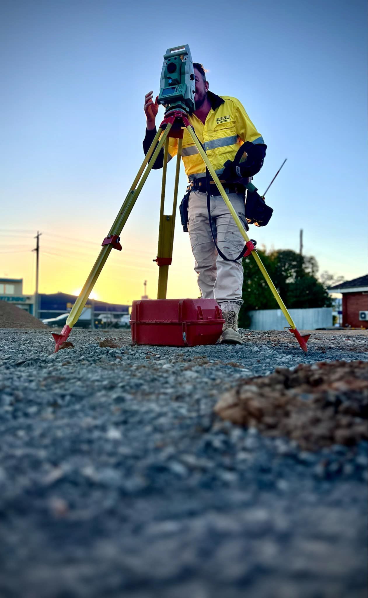 A Man is Standing on a Tripod Using a Camera — Point to Point Surveying In Cobram, VIC
