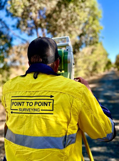A Construction Worker Is Using A Theodolite On A Tripod — Point to Point Surveying In Tatura, VIC