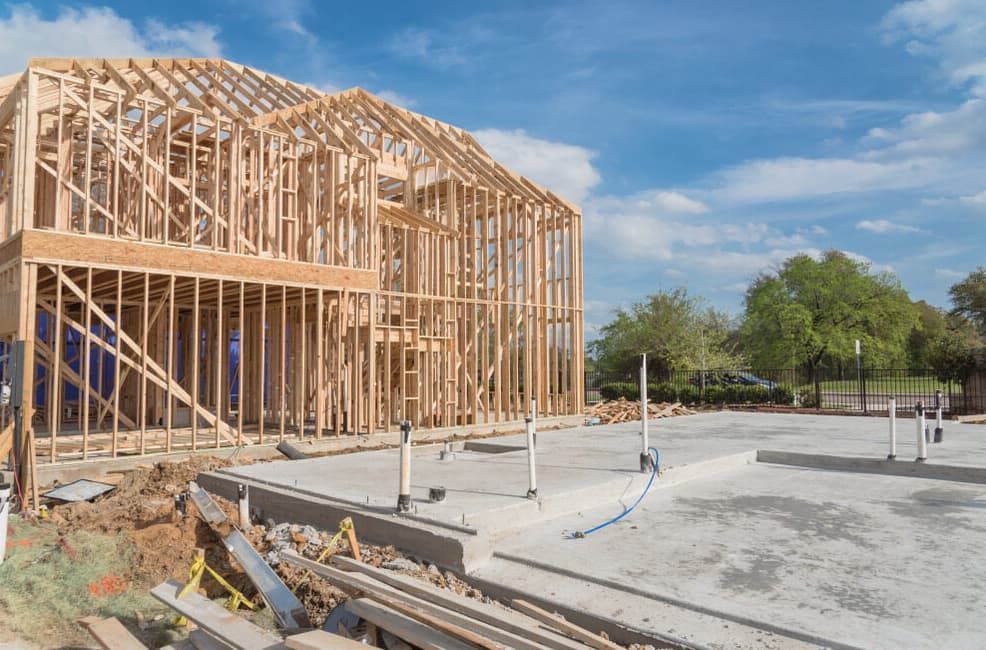 A House Is Being Built With A Lot Of Wooden Beams — Point to Point Surveying In Tatura, VIC