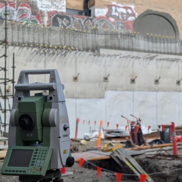 A Construction Site With Graffiti on the Wall and a Camera on the Ground — Point to Point Surveying In Tatura, VIC