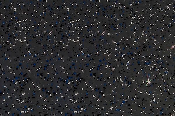 Dense star field with scattered blue and white stars on a dark sky background