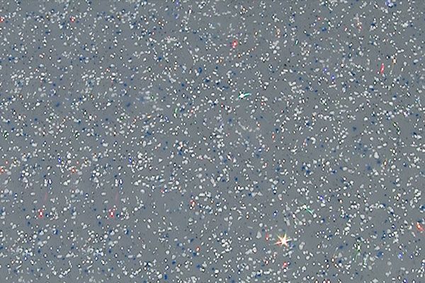 Gray starry sky with many small white specks and a bright star near the bottom center