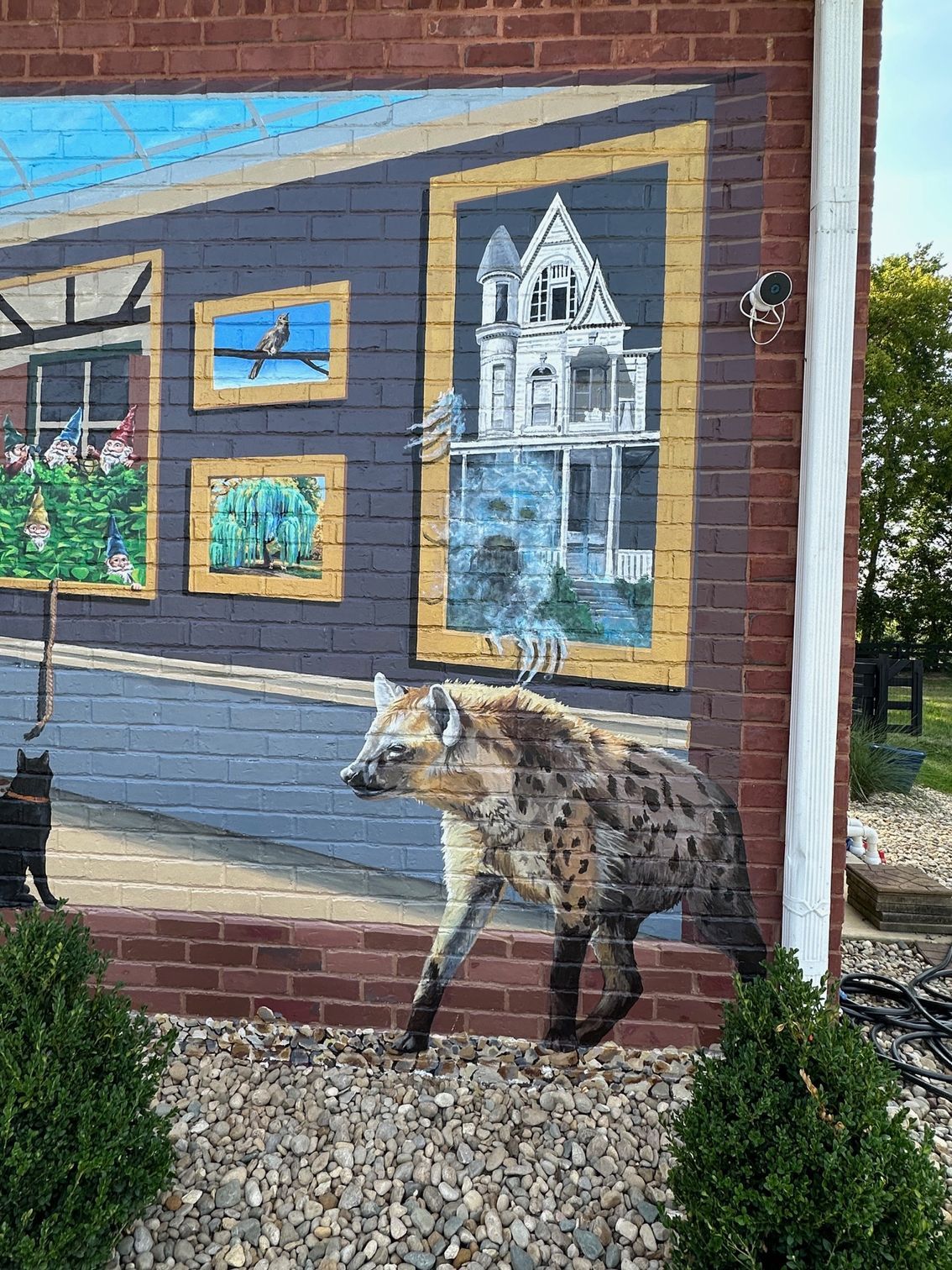 A mural of a hyena on a brick wall.