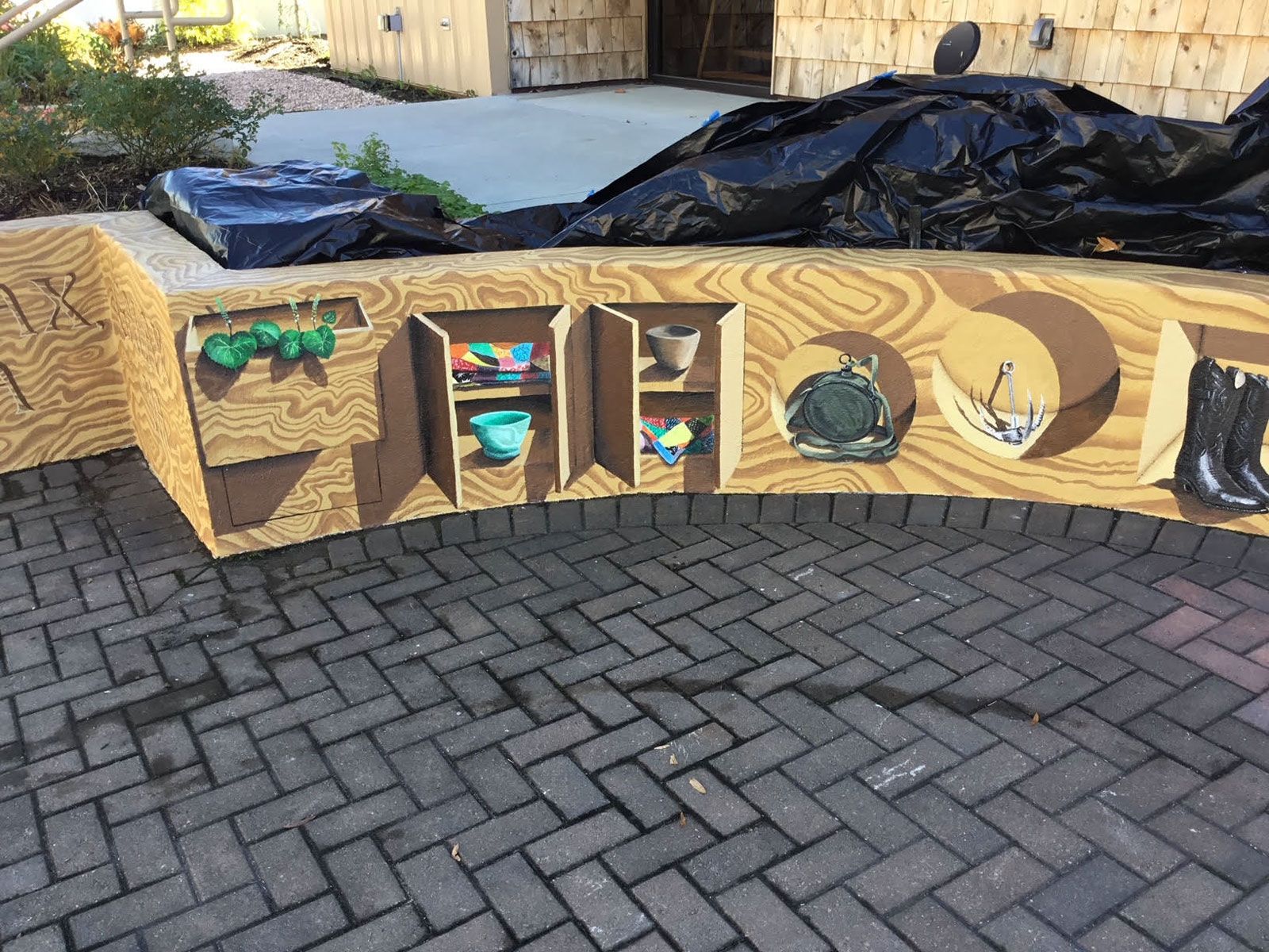 A wooden bench with the word first painted on it