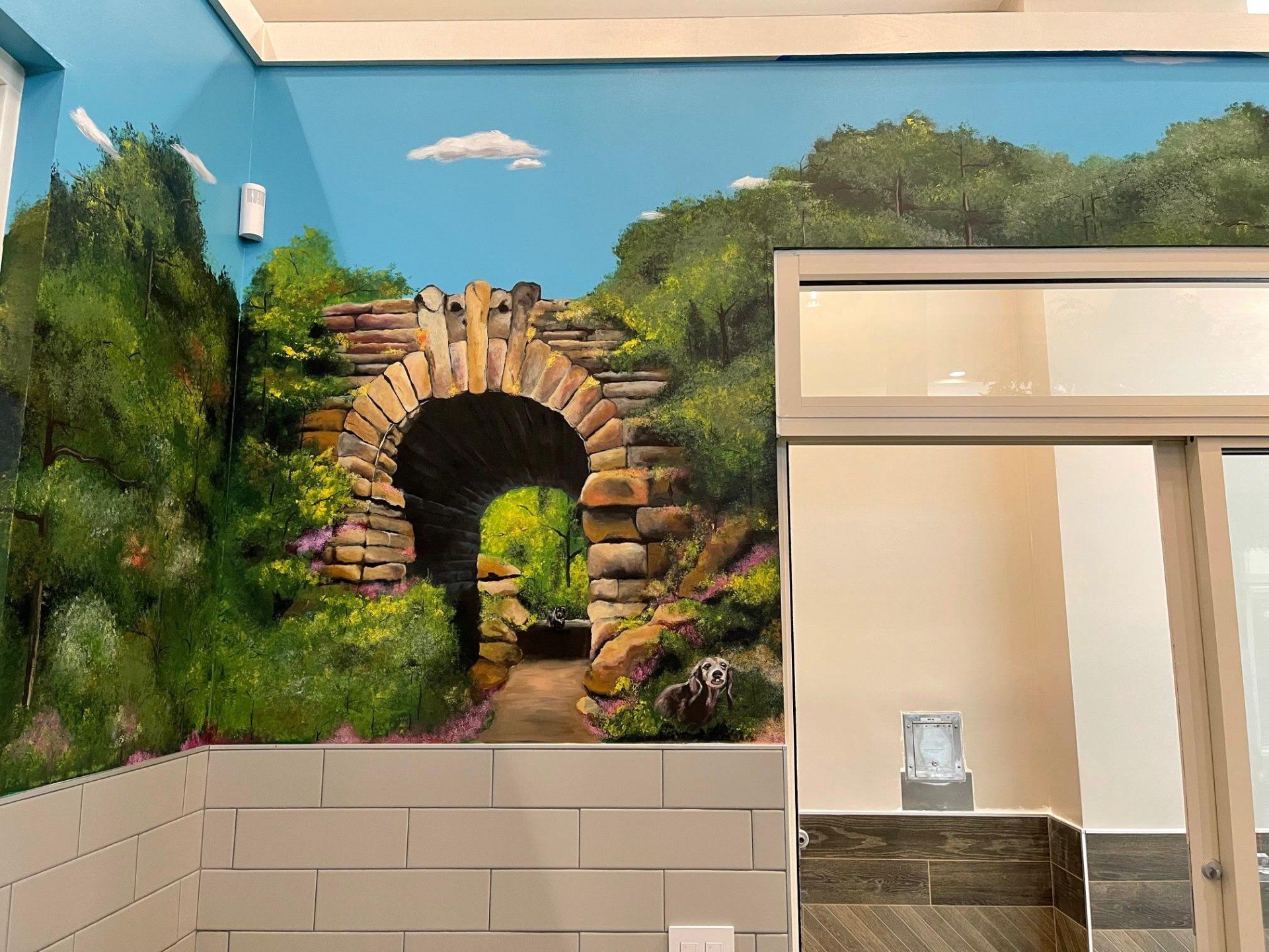 There is a painting of a stone archway on the wall.