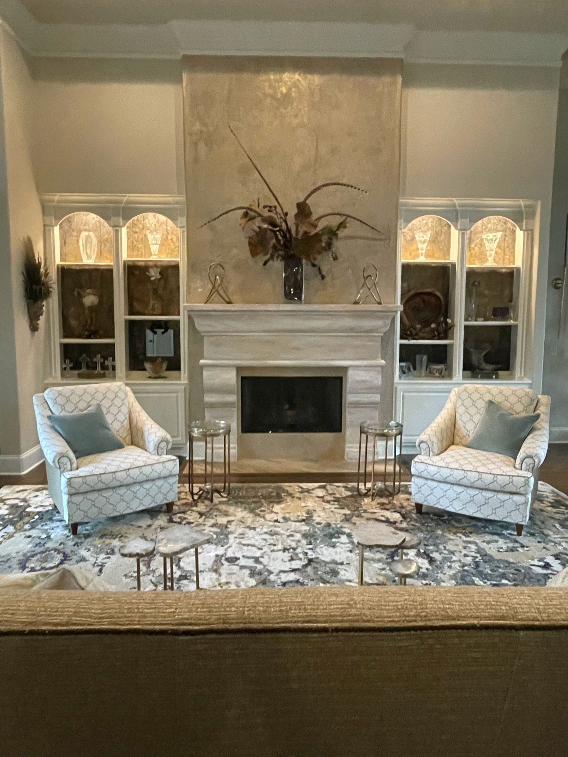 A living room with two chairs and a fireplace.