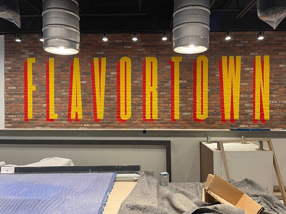 A brick wall with the word flavortown painted on it.