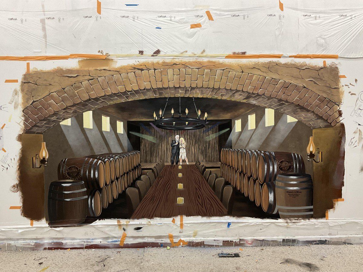A painting of a bride and groom in a wine cellar
