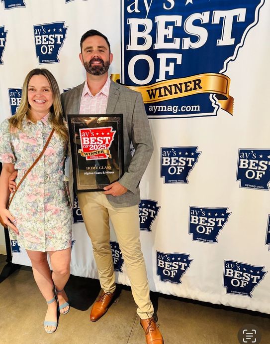 Alpine Glass & Window's owner, Mike, holding the AY's Best of 2025 award.