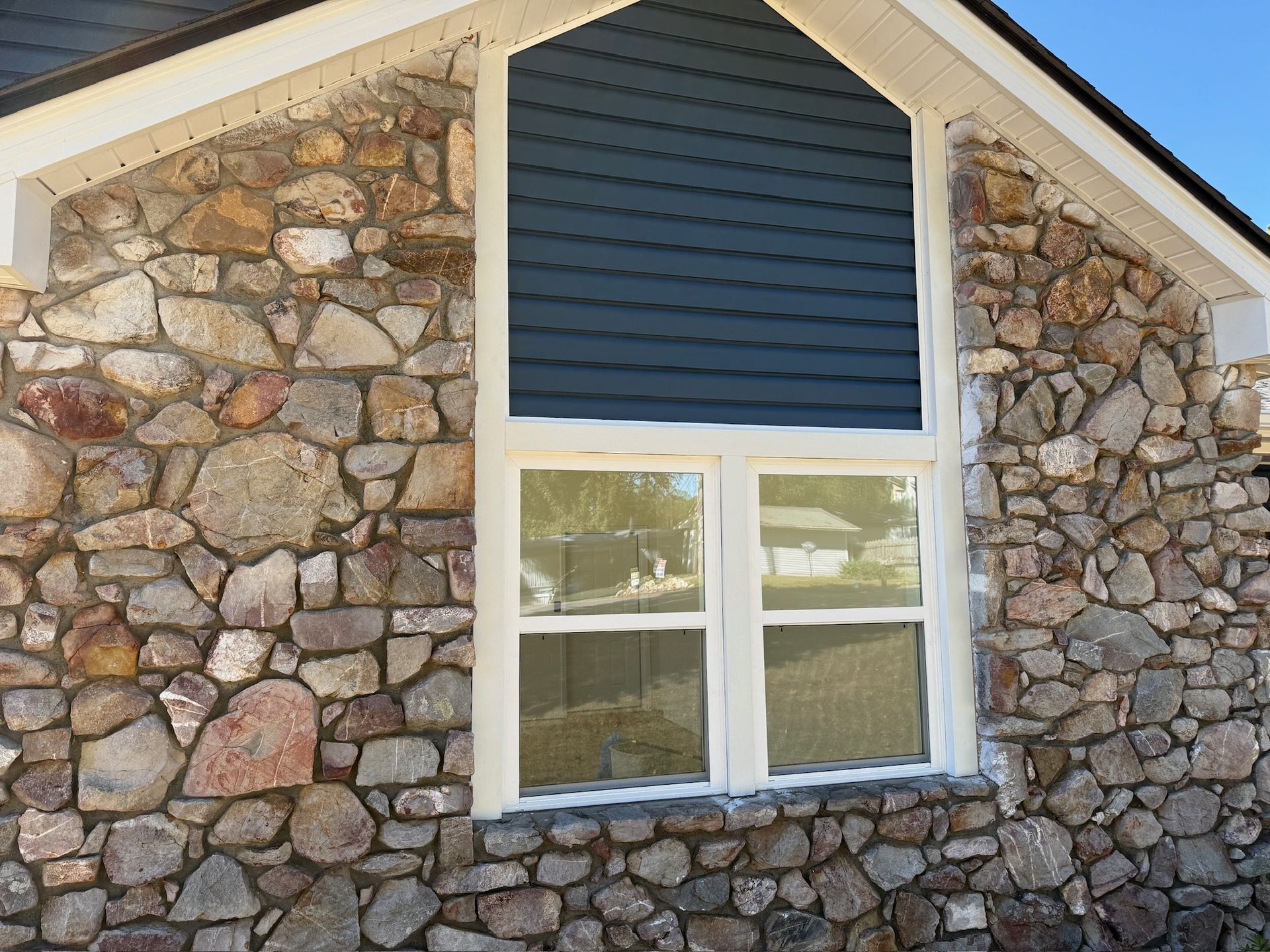 New window on a home with rock details.