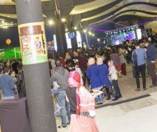 A large group of people are standing in a large room.