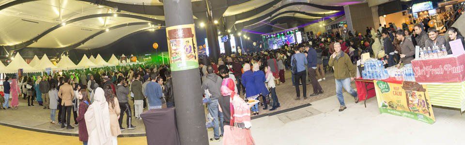 A large crowd of people are gathered in a large room.