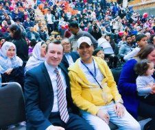 A group of people are sitting in a crowded stadium.