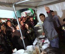 A man is standing in front of a crowd of people.