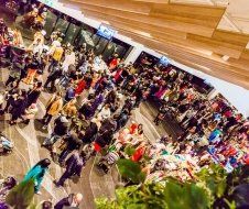 A large group of people are walking in a mall.