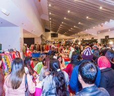 A large group of people are standing in a room.