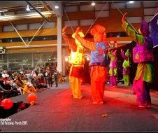 A group of people are dancing on a stage in front of a crowd.