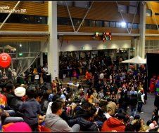 A large crowd of people are gathered in a large building