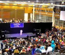 A large crowd of people are watching a performance on a stage