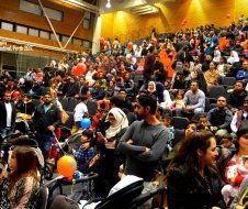 A large crowd of people are sitting in a stadium.