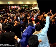 A large group of people are dancing in a crowd.