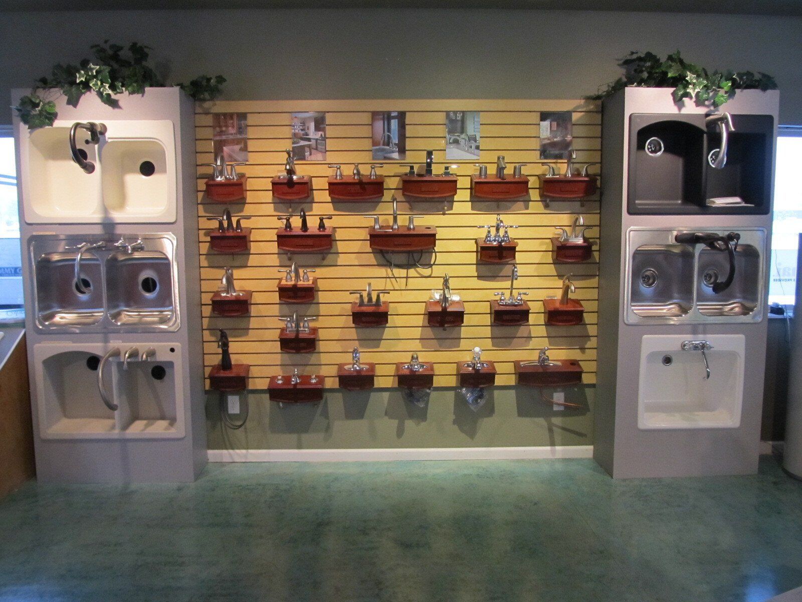 Pet cages lined on wall display in a pet store, with white and black units and a yellow backdrop.