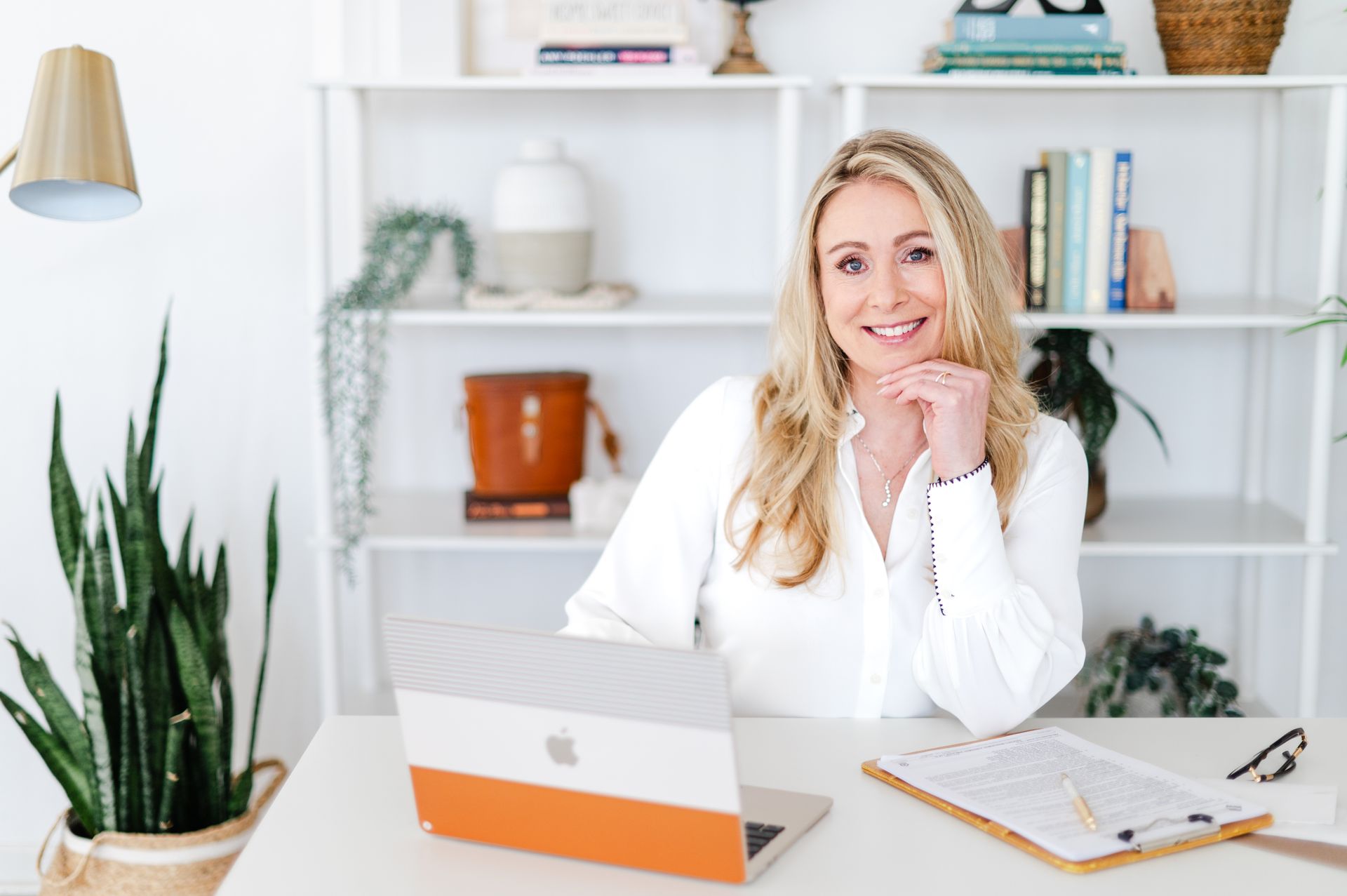 Andrea sitting at a desk with a c computer and smiling