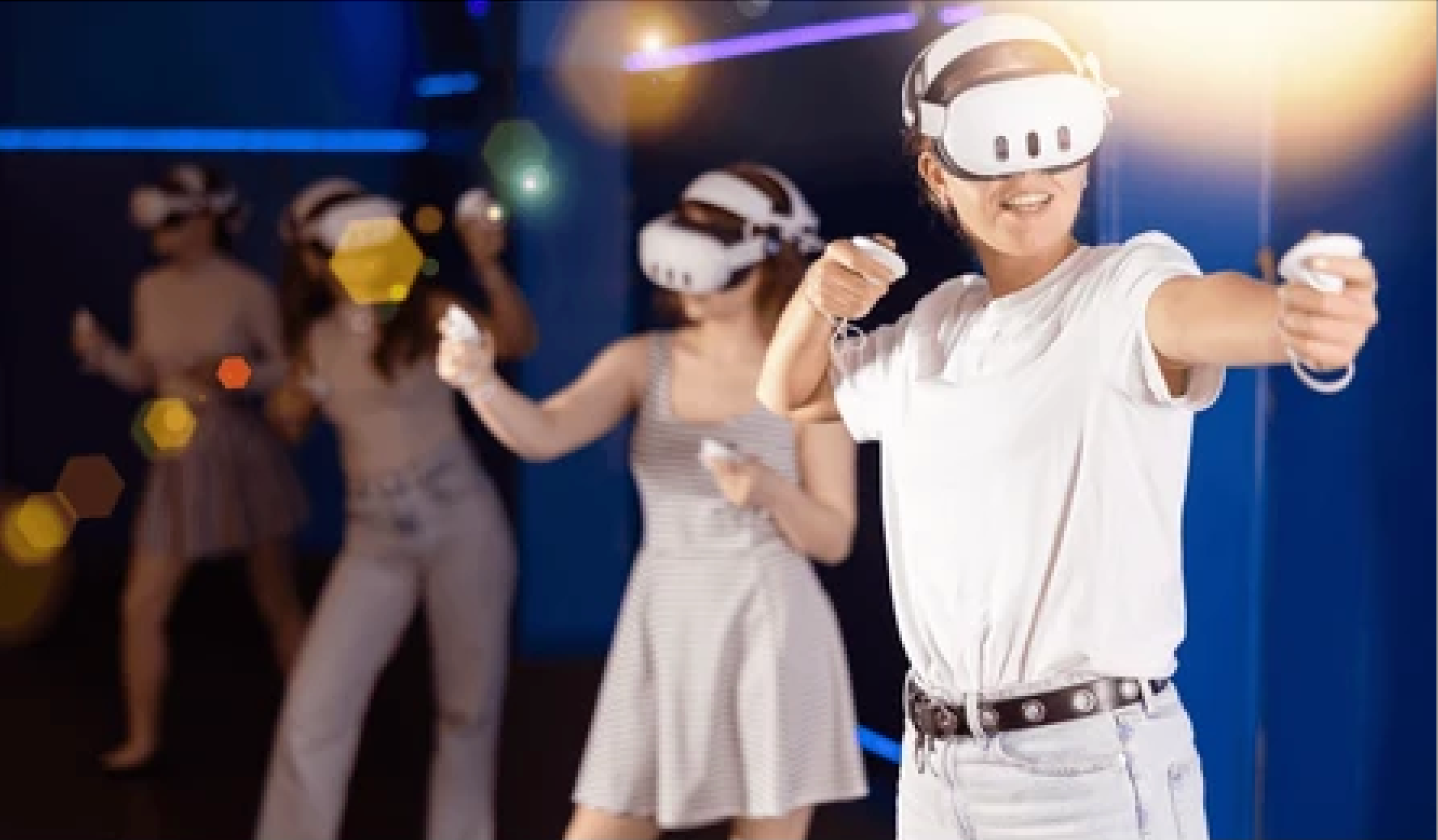 People wearing MetaQuest 3 VR headsets in a colourful arcade