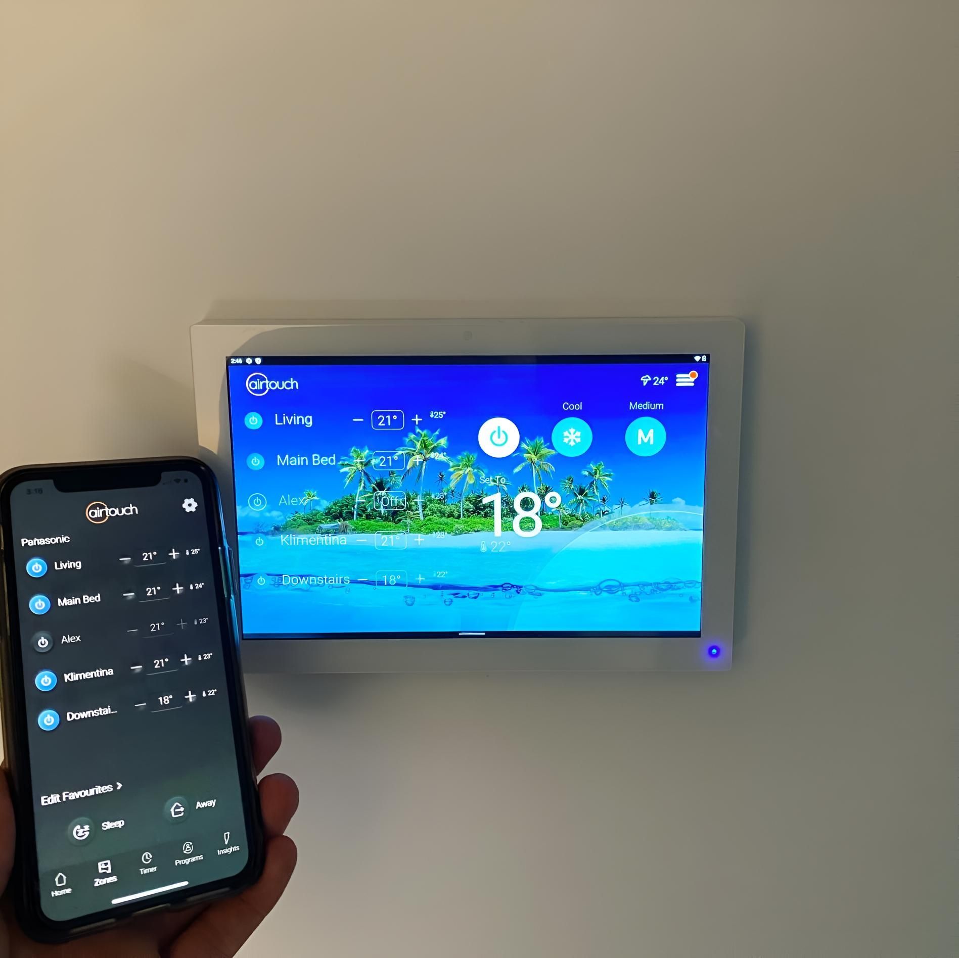 Person is Holding a Cell Phone in Front of a Screen — Kiama Air Conditioning in Berry, NSW