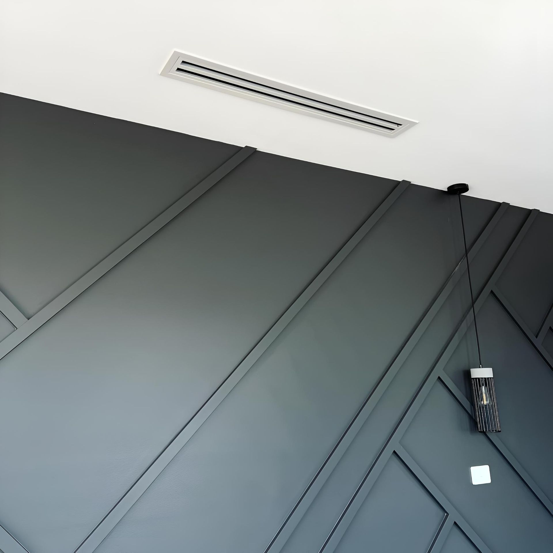 Gray Wall With a Light Hanging From the Ceiling — Kiama Air Conditioning in Albion Park Rail, NSW