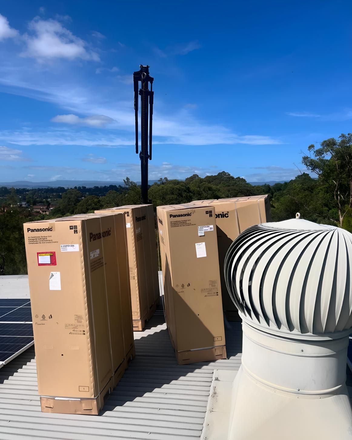 Three Cardboard Boxes Are Sitting on Top of a Roof — Kiama Air Conditioning in Albion Park Rail, NSW